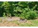 Outdoor fire pit and brick patio area offers a cozy spot for relaxation and entertainment at 3821 Whispering Branch Rd, Raleigh, NC 27613