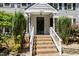 Inviting front entrance with brick steps and manicured bushes enhancing curb appeal at 3821 Whispering Branch Rd, Raleigh, NC 27613