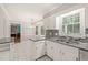 Bright kitchen with granite countertops, white cabinets, and stainless steel appliances at 3821 Whispering Branch Rd, Raleigh, NC 27613