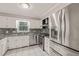 Updated kitchen features granite countertops, stainless steel appliances, and white cabinetry at 3821 Whispering Branch Rd, Raleigh, NC 27613