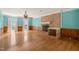 Bright living room features a brick fireplace, wood floors and a ceiling fan at 3821 Whispering Branch Rd, Raleigh, NC 27613