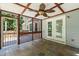 Inviting screened porch with stone flooring and outdoor access, ideal for entertaining or relaxation at 3821 Whispering Branch Rd, Raleigh, NC 27613