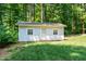Outdoor shed surrounded by lush greenery and trees, adding extra storage to the property at 3821 Whispering Branch Rd, Raleigh, NC 27613