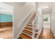 Beautiful stairway with wooden steps and white risers, leading to the home's upper level at 3821 Whispering Branch Rd, Raleigh, NC 27613