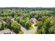 An aerial view showcases a tree-lined neighborhood and the property's location on a corner lot at 401 Westbury Dr, Chapel Hill, NC 27516