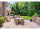 Spacious backyard featuring an outdoor kitchen, dining area, and fire pit with ample seating at 401 Westbury Dr, Chapel Hill, NC 27516
