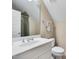 Well-lit bathroom featuring a sink, toilet, and shower with beige-colored walls at 401 Westbury Dr, Chapel Hill, NC 27516