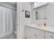 Bathroom featuring a white vanity with great storage, a large mirror, and a shower at 401 Westbury Dr, Chapel Hill, NC 27516