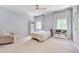 Bright bedroom with carpet, ceiling fan, neutral paint and two large windows at 401 Westbury Dr, Chapel Hill, NC 27516