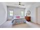 Bright bedroom with neutral carpet, two windows with bright light, and a ceiling fan at 401 Westbury Dr, Chapel Hill, NC 27516