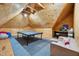 Finished bonus room with a ping pong table, couch, carpet, and wood paneling at 401 Westbury Dr, Chapel Hill, NC 27516