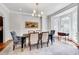 Beautiful dining room featuring a table set for six, elegant lighting, and a large window at 401 Westbury Dr, Chapel Hill, NC 27516