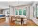 Dining room featuring large windows for abundant natural light, hardwood flooring, and backyard views at 401 Westbury Dr, Chapel Hill, NC 27516