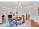 Bright dining room with hardwood floors, modern lighting, and elegant trim work throughout the space at 401 Westbury Dr, Chapel Hill, NC 27516