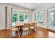 Charming dining room with large windows offering abundant natural light and backyard views at 401 Westbury Dr, Chapel Hill, NC 27516