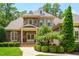 Detailed shot of a stately stone home with manicured landscaping, elegant architectural details, and a well-maintained lawn at 401 Westbury Dr, Chapel Hill, NC 27516
