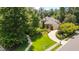 Aerial view of a well-maintained home with mature trees, manicured landscaping, and a circular driveway at 401 Westbury Dr, Chapel Hill, NC 27516