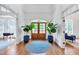 Bright foyer with hardwood floors, a circular rug, and double doors leading to the outside at 401 Westbury Dr, Chapel Hill, NC 27516