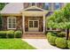 Elegant home entrance with stone steps, pillars, a decorative door, and manicured landscaping at 401 Westbury Dr, Chapel Hill, NC 27516