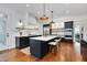 Open kitchen featuring custom cabinetry, marble countertops, and stainless-steel appliances at 401 Westbury Dr, Chapel Hill, NC 27516