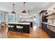 Bright, open kitchen featuring a central island with seating and stainless steel appliances at 401 Westbury Dr, Chapel Hill, NC 27516