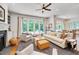 Bright living room featuring a cozy fireplace, large windows, and an adjacent dining area at 401 Westbury Dr, Chapel Hill, NC 27516