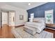 Main bedroom featuring hardwood floors, a king bed, and ensuite bathroom at 401 Westbury Dr, Chapel Hill, NC 27516