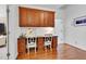 Home office featuring custom built-in cabinetry and desk area with hardwood flooring and natural light at 401 Westbury Dr, Chapel Hill, NC 27516