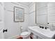 Modern powder room featuring wainscoting and a pedestal sink with elegant fixtures at 401 Westbury Dr, Chapel Hill, NC 27516
