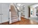 Carpeted staircase with wood railing, white trim and natural light at 401 Westbury Dr, Chapel Hill, NC 27516