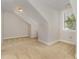 A carpeted attic room with natural light from a window at 410 Stranraer Ct, Fuquay Varina, NC 27526