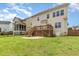 The spacious yard boasts a sizable wooden deck and lush green grass, creating an ideal setting for relaxation and entertainment at 410 Stranraer Ct, Fuquay Varina, NC 27526