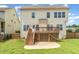Expansive backyard features a large wooden deck, a stone patio, and a well-manicured lawn, perfect for outdoor gatherings at 410 Stranraer Ct, Fuquay Varina, NC 27526