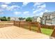 A backyard featuring a wooden deck and a view of the neighborhood on a sunny day at 410 Stranraer Ct, Fuquay Varina, NC 27526