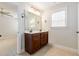 The bathroom features a double sink vanity, large mirror with decorative lighting, and tile floors at 410 Stranraer Ct, Fuquay Varina, NC 27526