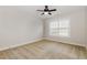 A bright bedroom with neutral colored walls, carpet flooring, a ceiling fan, and a large window at 410 Stranraer Ct, Fuquay Varina, NC 27526