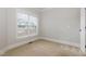 A carpeted room with a window overlooking a neighborhood at 410 Stranraer Ct, Fuquay Varina, NC 27526