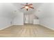 This bonus room features neutral walls and carpet flooring, a ceiling fan, and a view of another room at 410 Stranraer Ct, Fuquay Varina, NC 27526