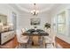 Elegant dining room boasts a modern black marble table, plush rug, and decorative chandelier at 410 Stranraer Ct, Fuquay Varina, NC 27526