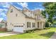 Home's exterior shows a side entry two-car garage and manicured landscaping in a suburban setting at 410 Stranraer Ct, Fuquay Varina, NC 27526