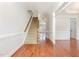 Foyer features hardwood floors, a carpeted staircase, and views to other rooms at 410 Stranraer Ct, Fuquay Varina, NC 27526