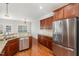 Kitchen featuring wooden cabinets, stainless steel appliances, and granite countertops at 410 Stranraer Ct, Fuquay Varina, NC 27526