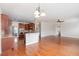 Open-concept living space flowing into a kitchen, featuring hardwood floors, modern lighting, and a breakfast bar at 410 Stranraer Ct, Fuquay Varina, NC 27526
