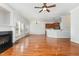 Open concept living room featuring hardwood floors, a ceiling fan, and open access to the kitchen at 410 Stranraer Ct, Fuquay Varina, NC 27526