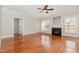 Spacious living room featuring a decorative fireplace, hardwood floors, and large windows with natural light at 410 Stranraer Ct, Fuquay Varina, NC 27526