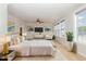 Spacious bedroom featuring a king bed, sitting area, plush carpet, and ample natural light at 410 Stranraer Ct, Fuquay Varina, NC 27526
