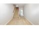 Carpeted staircase with wood railing in a brightly lit hallway at 410 Stranraer Ct, Fuquay Varina, NC 27526
