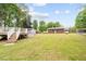 Large backyard featuring a spacious deck, storage shed, above-ground pool, and plenty of greenery at 410 W Tenth St, Siler City, NC 27344