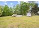 Sprawling backyard featuring an above ground pool, storage shed, and lush green lawn at 410 W Tenth St, Siler City, NC 27344