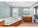 The main bathroom has a bathtub with tile flooring and a wooden vanity at 410 W Tenth St, Siler City, NC 27344